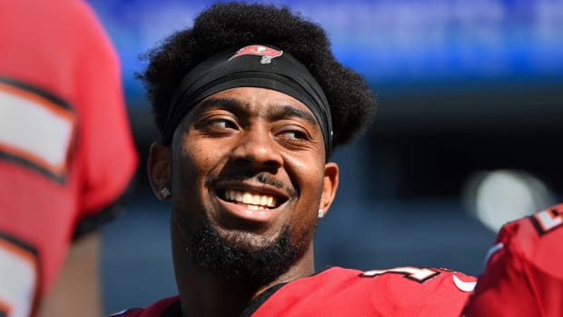 Buccaneers wide receiver Russell Gage smiles with his helmet off before a game.